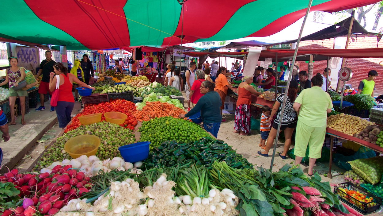 Shoppers use large plastic buckets to select the produce they will purchase.